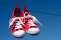 New red sneakers on washing line Royalty Free Stock Photo