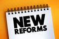 New Reforms text on notepad, concept background Royalty Free Stock Photo