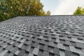 new renovated roof covered with shingles flat polymeric roof-tiles