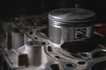 a new repair piston of the internal combustion engine lies on a disassembled engine in the workshop Royalty Free Stock Photo