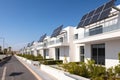 New residential area with white modern family houses, newly built modern family homes. Row of modern houses with solar Royalty Free Stock Photo