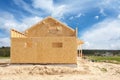 New residential construction home framing against a blue sky. Royalty Free Stock Photo