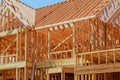 New residential construction home framing against a blue sky. Royalty Free Stock Photo