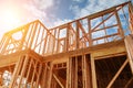 New residential construction home framing against a blue sky.