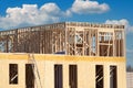 New residential construction home framing against a blue sky Royalty Free Stock Photo