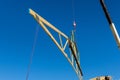 New residential construction home framing against a crane holds is new in wood roofing Royalty Free Stock Photo