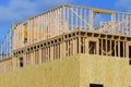 new residential construction house framing against a blue sky Royalty Free Stock Photo