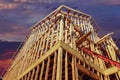 New residential construction house framing against a sunset Royalty Free Stock Photo