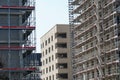 New residential district or quarter in construction, apartment houses in different stages of progress with scaffolding or without Royalty Free Stock Photo