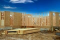 New residential frame house under construction against a blue sky timber wall Royalty Free Stock Photo