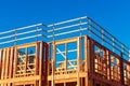 New residential wood framed building construction under blue sky Royalty Free Stock Photo