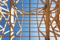 New residential wooden construction home framing against a blue sky.