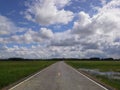 New road on fields on bright sky Hadyai,Thailand