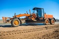 New roadworking tractor standing on edge of road Royalty Free Stock Photo