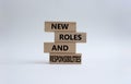 New roles and responsibilities symbol. Wooden blocks with words New roles and responsibilities. Beautiful white background. Royalty Free Stock Photo