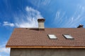 New roof with skylight, asphalt roofing shingles and chimney. Roof with mansard windows Royalty Free Stock Photo