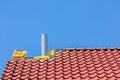 New roof with roof tiles and chimney pipe