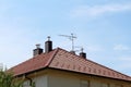 New roof tiles with modern chimneys and multiple TV antennas on top of renovated suburban family house Royalty Free Stock Photo