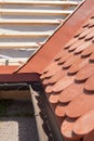 New roof under construction with wooden beams, waterproofing layer for corner and natural tile. Royalty Free Stock Photo