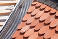 New roof under construction with wooden beams, waterproofing layer for corner and natural tile. Royalty Free Stock Photo