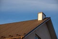 New roofing construction with attic skylights, rain gutter system, roof windows and roof protection from snow board Royalty Free Stock Photo