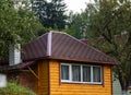 New roofing construction with attic skylights, rain gutter system, roof windows and roof protection from snow board Royalty Free Stock Photo