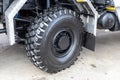 A new rubber truck tire or an off-road vehicle. Off-road capability, the tread or protector. Auto store or dealership or