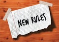 NEW RULES handwritten on torn notebook page crumpled paper on wood texture background.