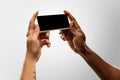 Close up male hands holding phone with blank screen during online watching of popular sport matches and championships Royalty Free Stock Photo