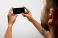 Close up male hands holding phone with blank screen during online watching of popular sport matches and championships Royalty Free Stock Photo