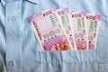 New 2000 rupee notes in an Indian mans shirts front pocket. Royalty Free Stock Photo