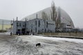 New Safe Confinement above remains of reactor 4 and old sarcophagus at Chernobyl nuclear power plant. Ukraine.