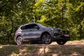 New Seat Tarraco in grey colour on the road in forest. New Seat SUV luxury vehicle.