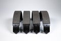 New set of four brake pads for drum brakes on a gray background