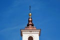 new shiny sloped red copper church roof and stucco bell tower. blue sky. arched window Royalty Free Stock Photo