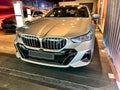 A new silver car is displayed in a car showroom. LED headlights. Front bumper with radiator grille Royalty Free Stock Photo