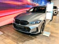 A new silver car is displayed in a car showroom. LED headlights. Front bumper with radiator grille Royalty Free Stock Photo