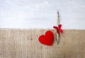 New silver pen gift and red heart on hessian fabric over white wood background Royalty Free Stock Photo