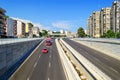 New six lane asphalt road with storm sewer preventing flooding the road under the bridge. Cityscape and transportation on a sunny