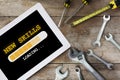 New skills loading on digital computer tablet and tools supplies on wooden background Royalty Free Stock Photo