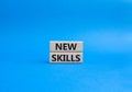 New skills symbol. Concept words new skills on wooden blocks. Beautiful blue background. Business and new skills concept. Copy Royalty Free Stock Photo