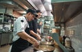 New skills. Two chef assistants cooking a new dish in a restaurant kitchen.