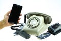 New smart phone with old telephone on white background. New communication technology Royalty Free Stock Photo