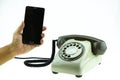 New smart phone with old telephone on white background. New communication technology Royalty Free Stock Photo