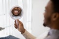 New Smile. Black Man Looking At Mirror While Sitting In Dentist Chair Royalty Free Stock Photo