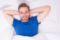 New smile, new day. Happy man awaken in bed. Handsome caucasian man with happy smile relaxing in the morning. Sparkling Royalty Free Stock Photo