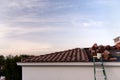 New Spanish style roof tile installation in the afternoon light. Royalty Free Stock Photo