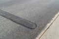 New speed bump on asphalt road Royalty Free Stock Photo