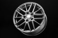 new sporty lightweight alloy wheel, spokes and rim on a black background Royalty Free Stock Photo