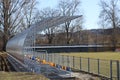 New stands on the football field of metal light construction with plastic seats in blue and yellow. Places for fans in the stadium